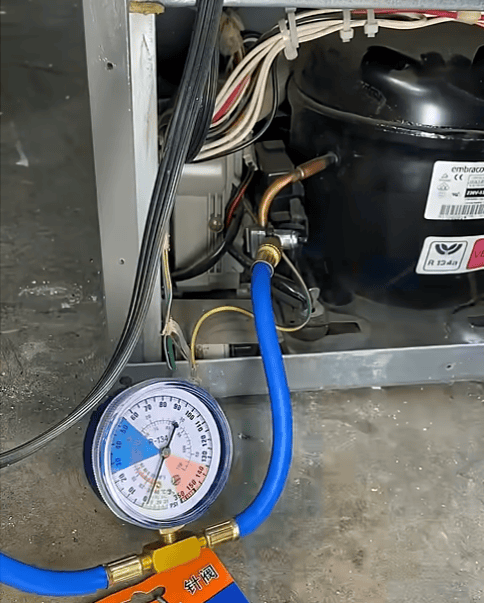 Refrigerator refrigerant pressure test with gauge